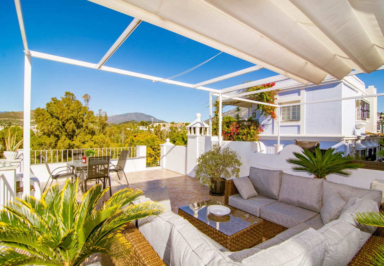 Large terrace with fantastic views over Nueva Andalucia. BBQ, dining table and lounge. Aloha Pueblo 